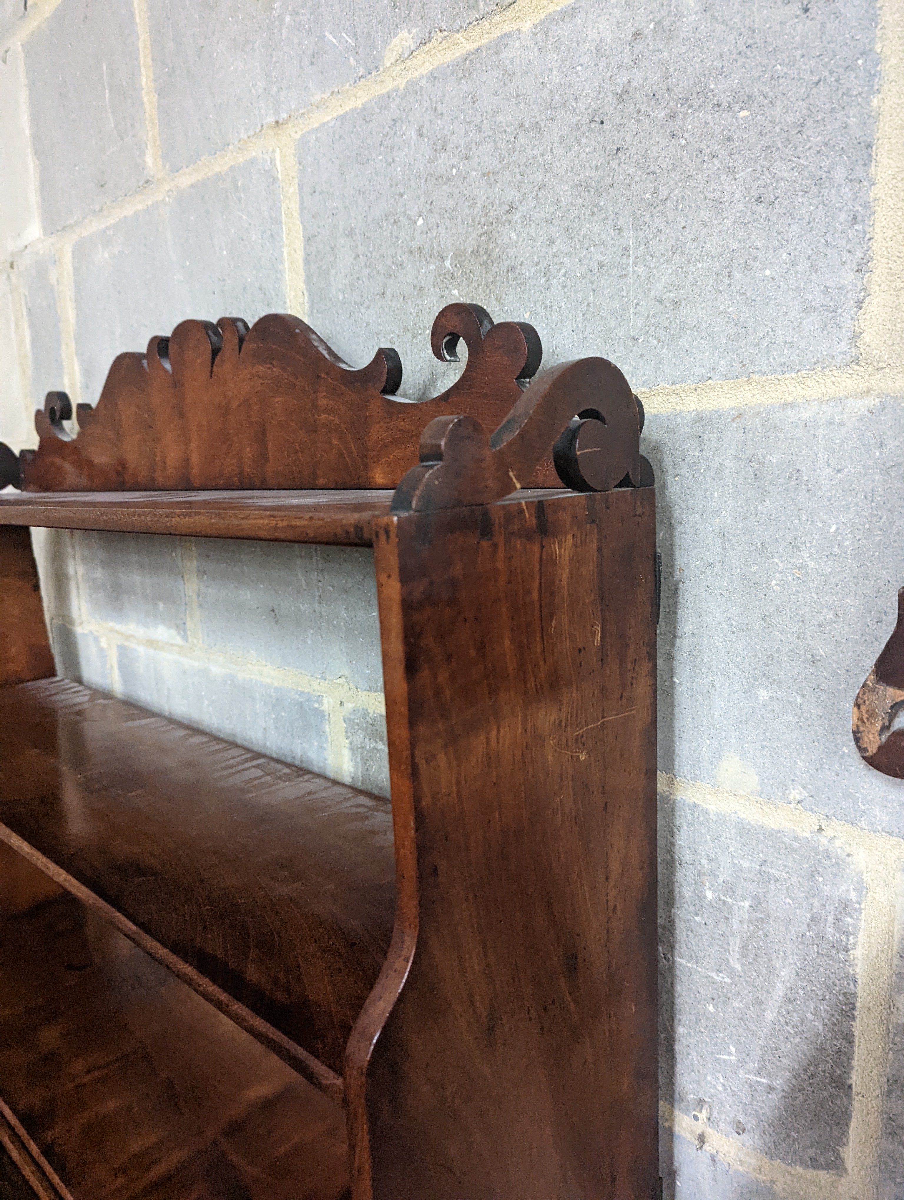 A Victorian mahogany wall bracket. W-90cm, D-22cm, H-70cm.